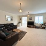 Spacious living room with sofas and TV.